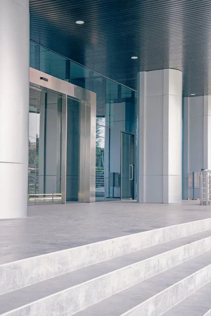 Side view of young ethnic male in uniform cleaning floor with mop while working in retro styled restaurant